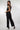 Magasinez la combinaison à haut brillant de Colori - Shop the shiny top jumpsuit from Colori